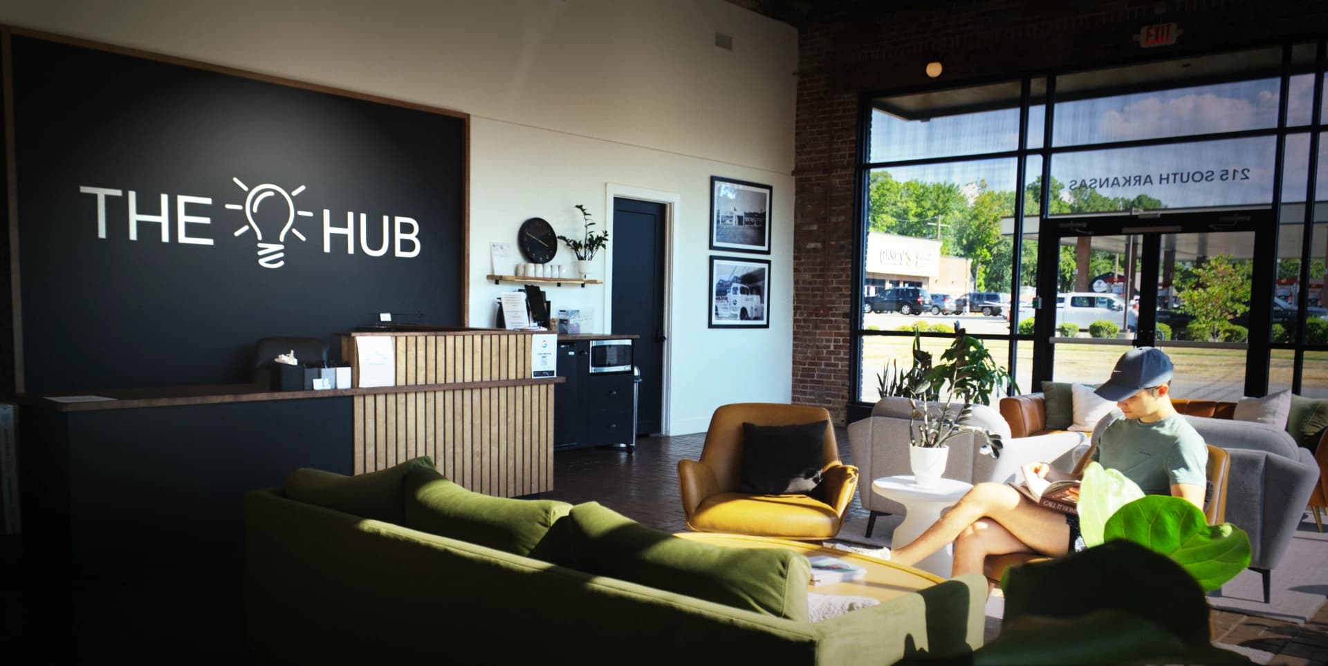 The Hub lobby with Oliver Lounge sign and member working